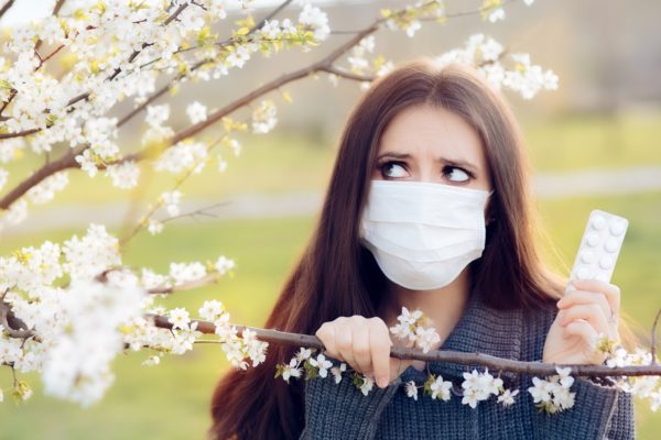 Woman with Respirator Mask Fighting Spring Allergies Outdoor