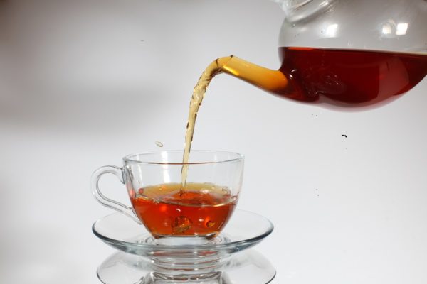 Pouring tea to a teacup